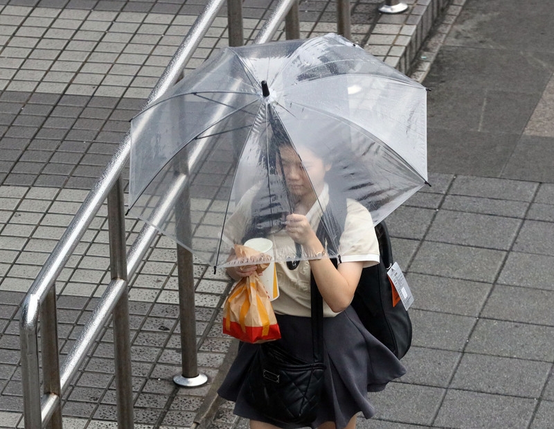 圖為台北市民眾撐傘遮擋雨勢。（中央社記者郭日曉攝）